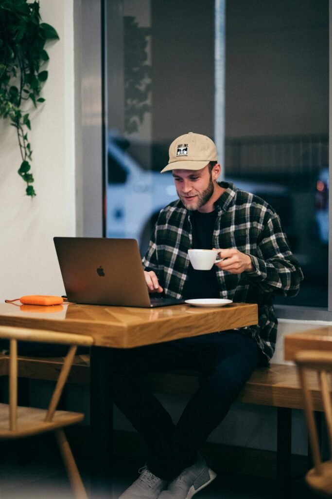 Man having coffee and using laptop